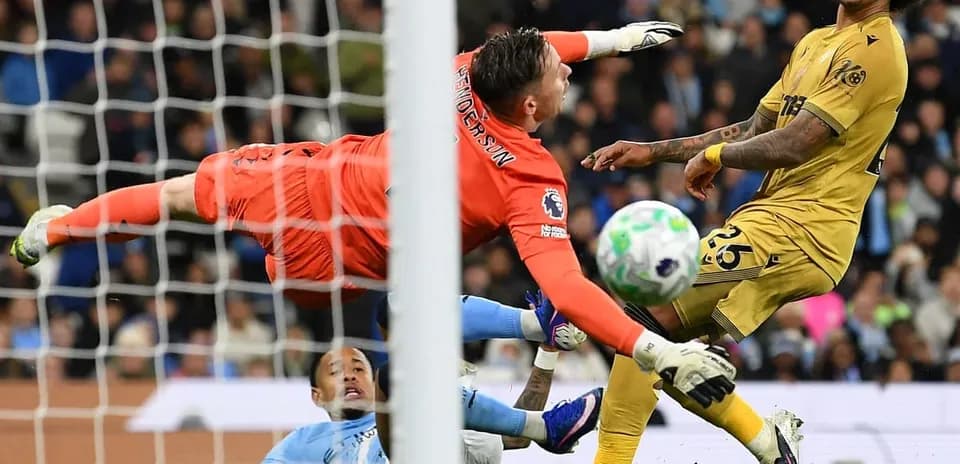Goalkeeper diving to save shot during match