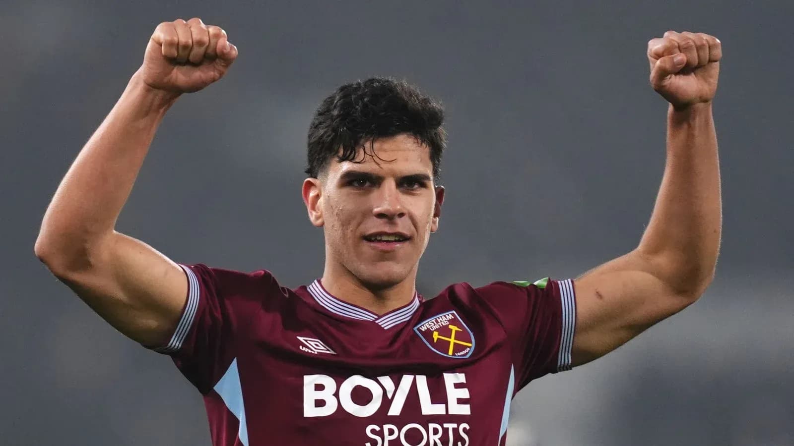 Player celebrating with raised fists in West Ham kit