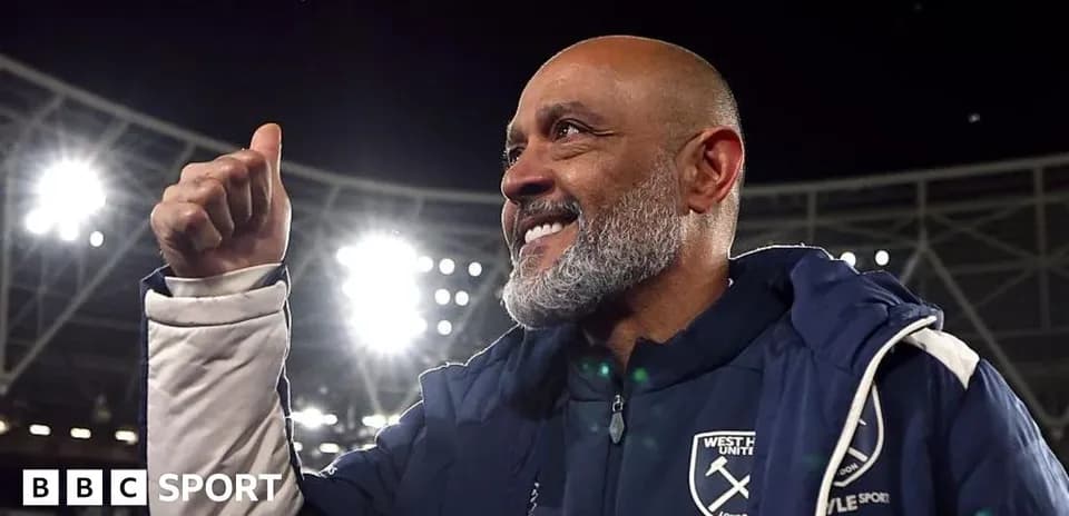 Manager celebrating victory at stadium with raised thumb