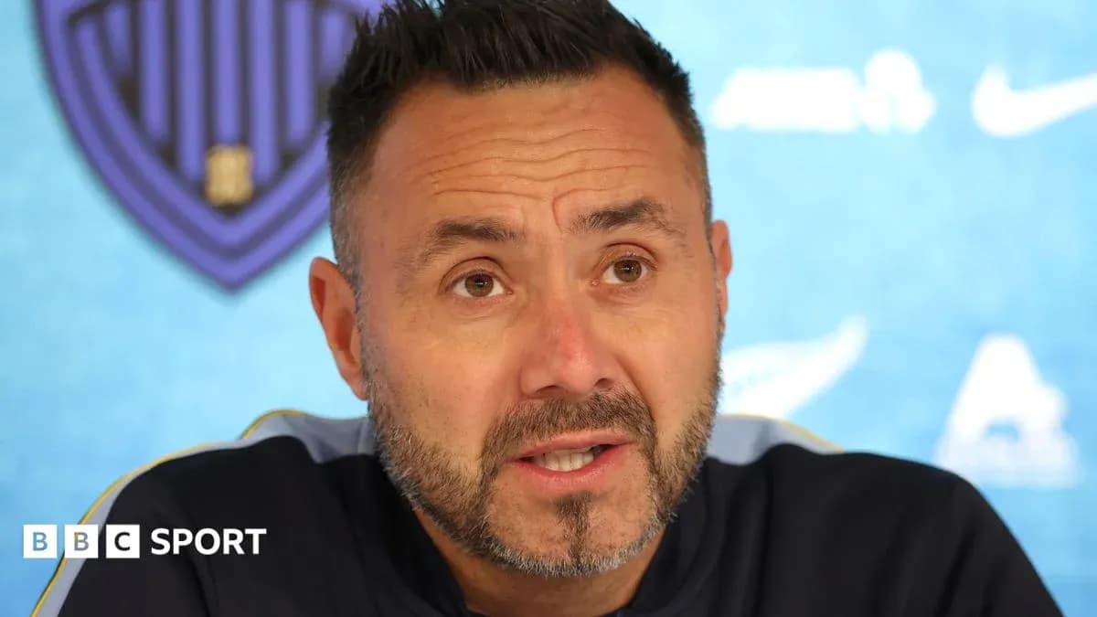 Manager speaking at press conference with team logo