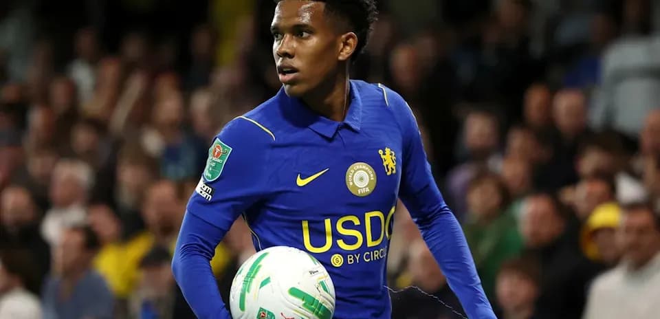 Player in blue kit holding a football during match
