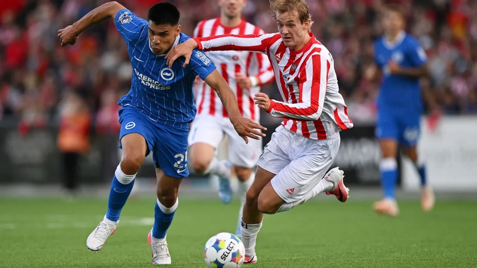 Player in blue and player in red competing for ball