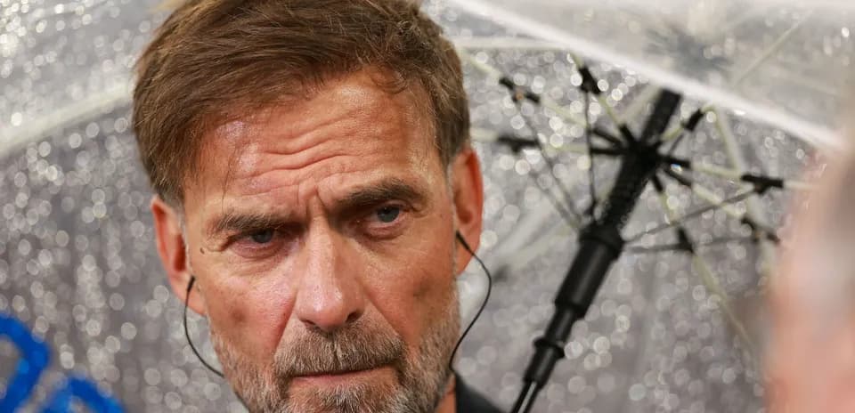 Manager speaking under an umbrella during rain