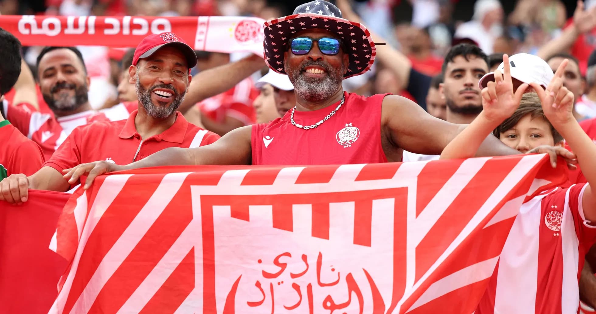 Fans celebrating with a flag at a match