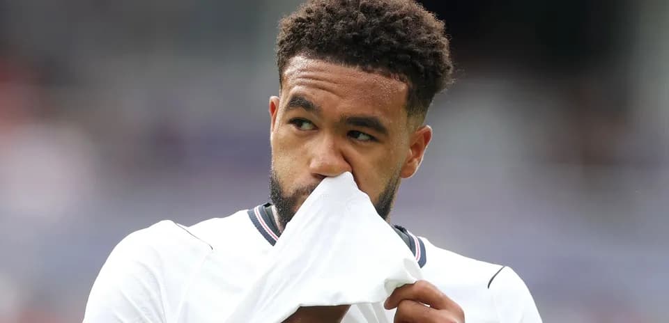 Player holding shirt to his face on the field
