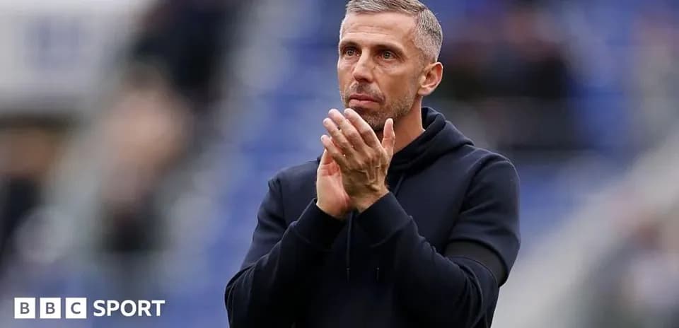 Coach applauding fans during a match