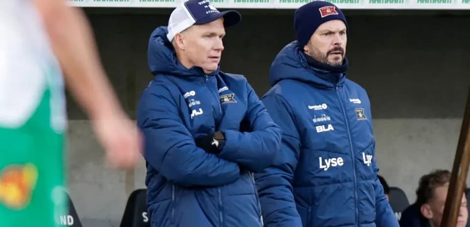 Coaches observing from the sidelines during match