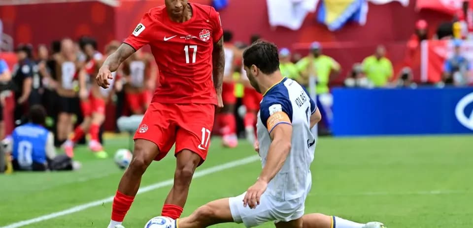 Canada player evading tackle during World Cup match