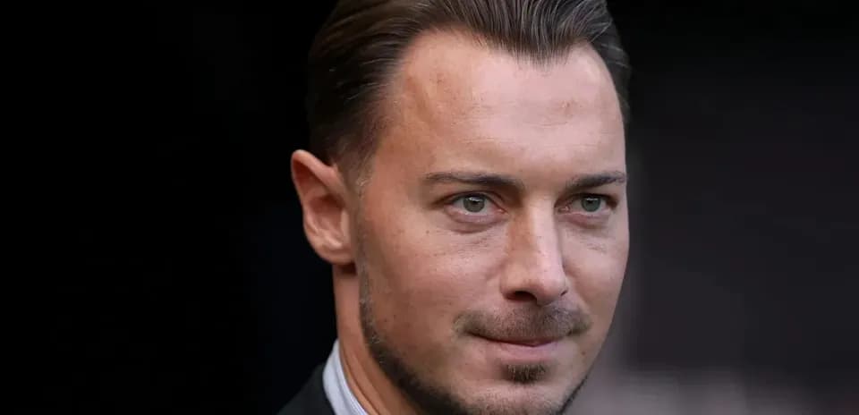 Close-up of a man in a suit, serious expression