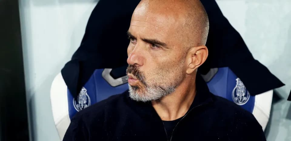 Coach sitting on bench during match