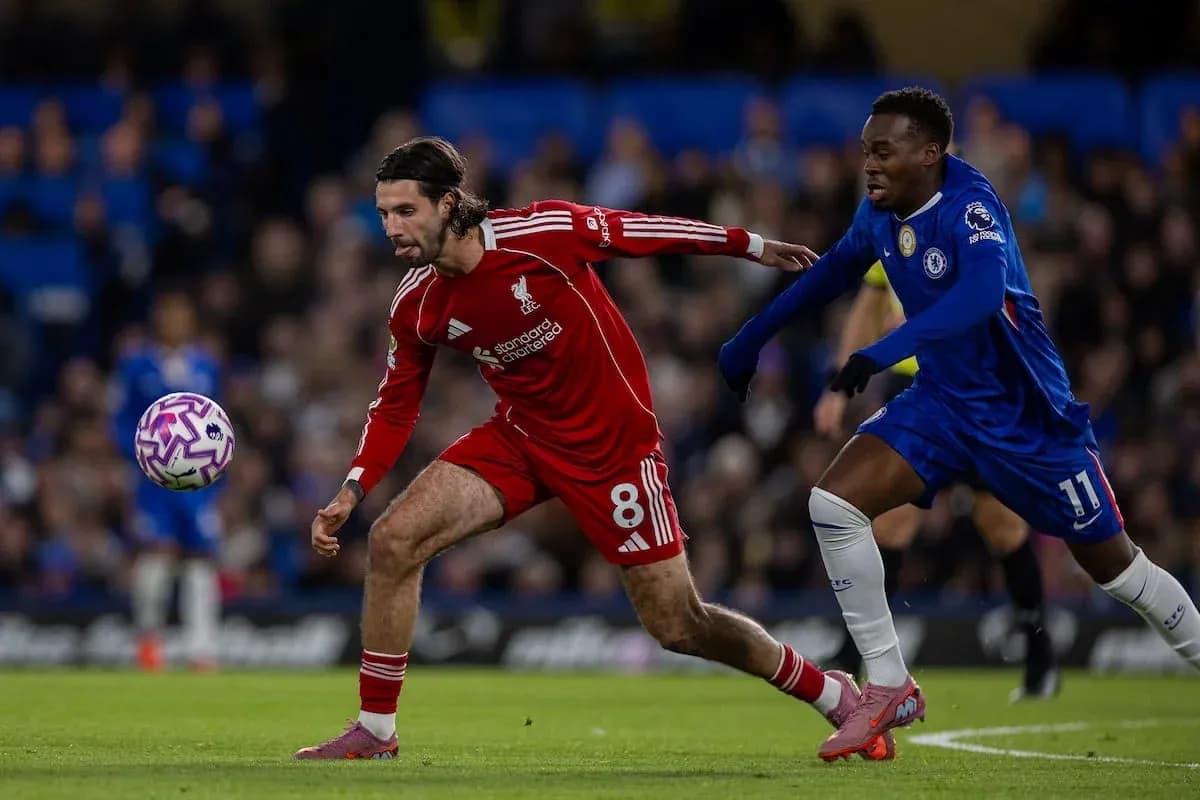 Liverpool player tackling Chelsea opponent during match