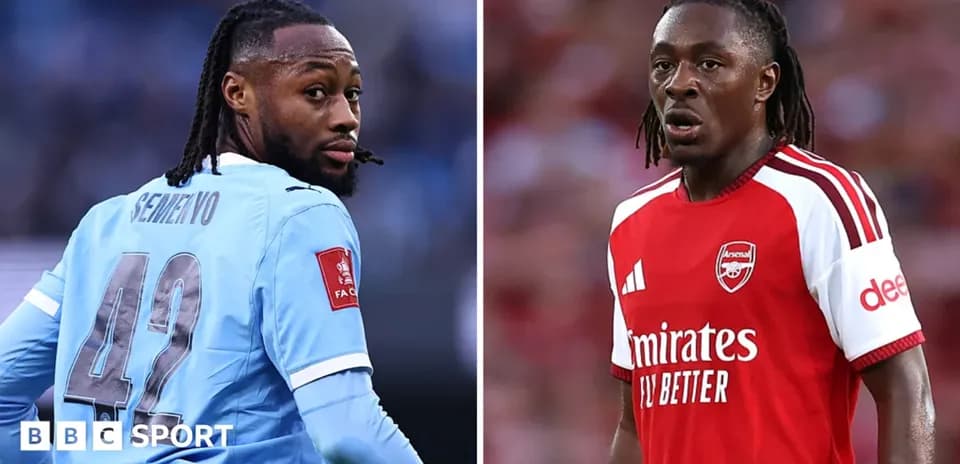 Two football players in team kits facing opposite directions