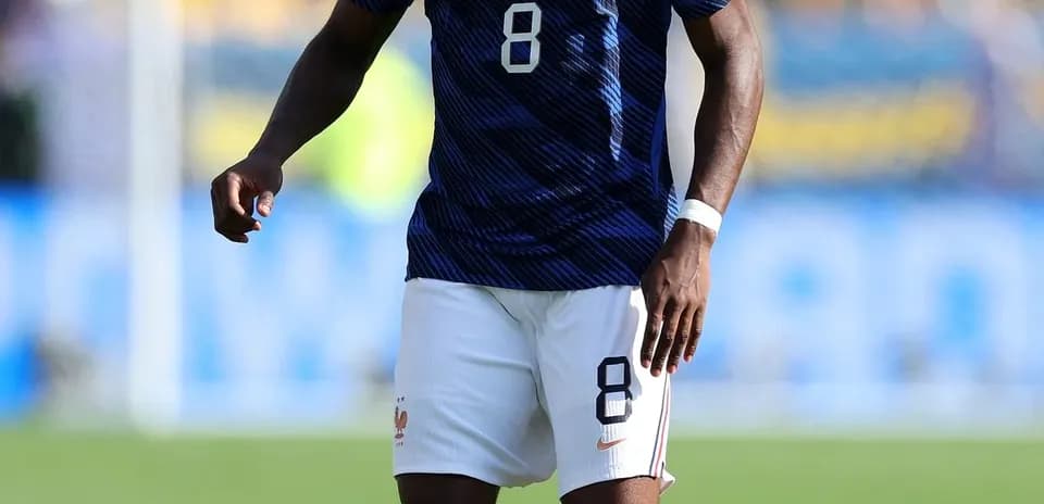 Player in blue France kit with ball on field