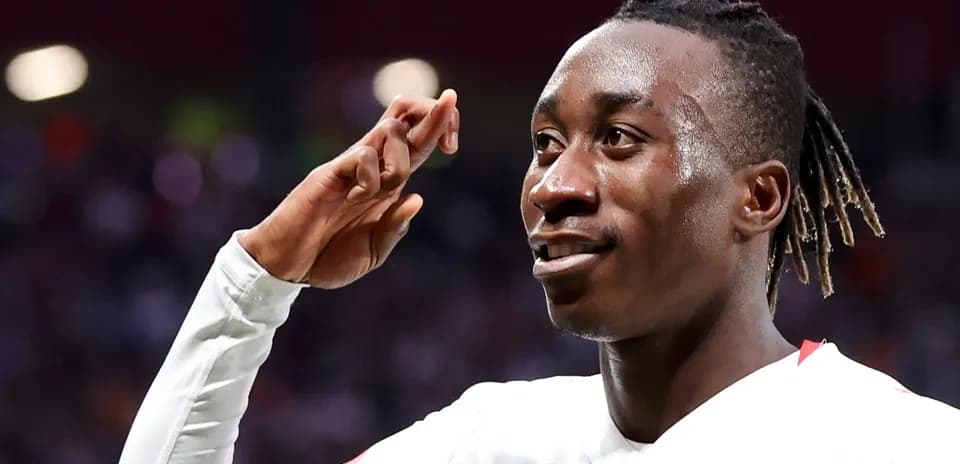 Player celebrating with hand salute after scoring