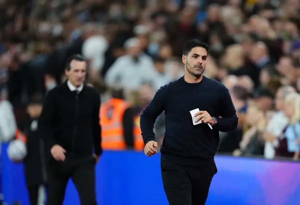 Two football managers walking on the sideline