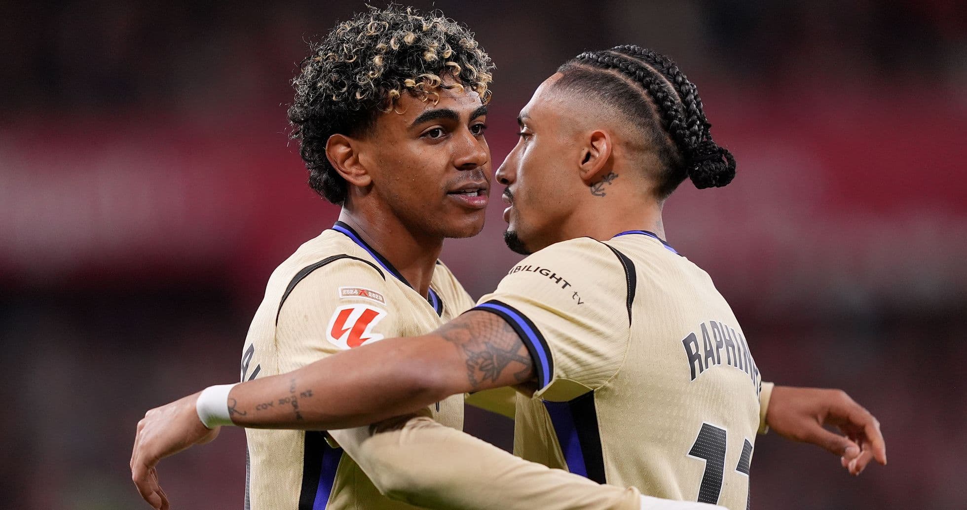 Two players embracing on the field during match