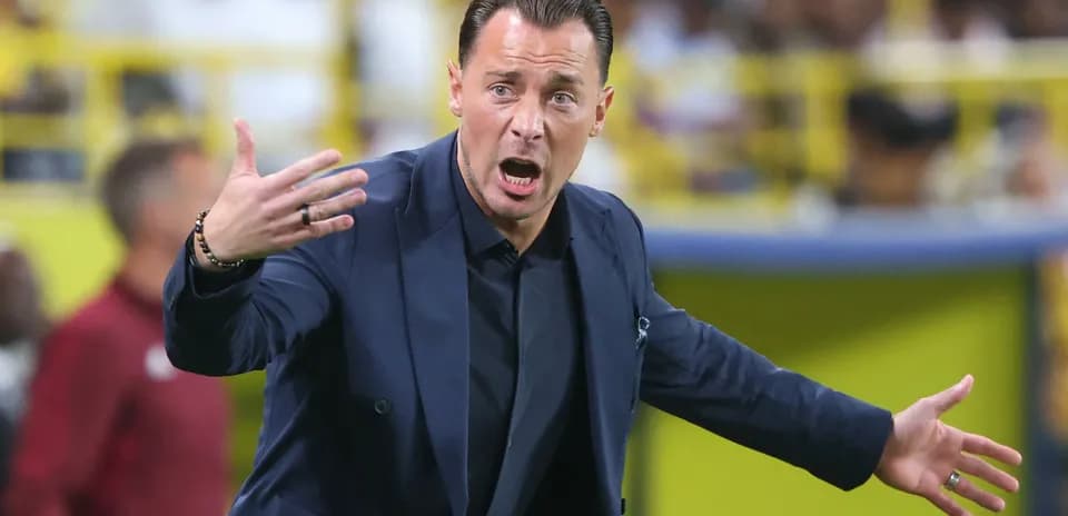 Coach gesturing during a football match