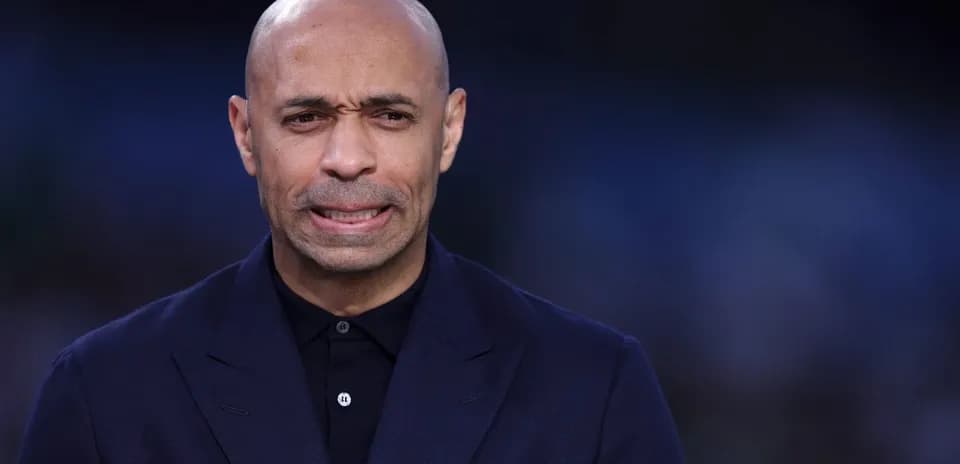 Man in dark suit speaking at event