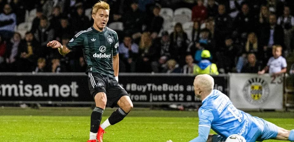 Player dribbling past goalkeeper during match