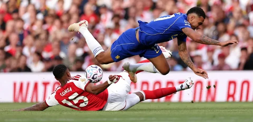 Player falls while challenging for the ball during match