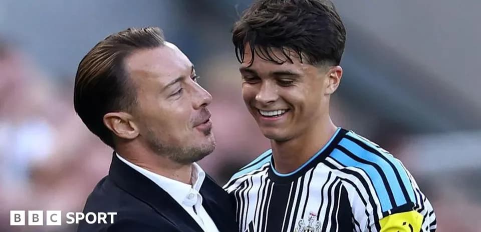 Coach and player celebrating on the field