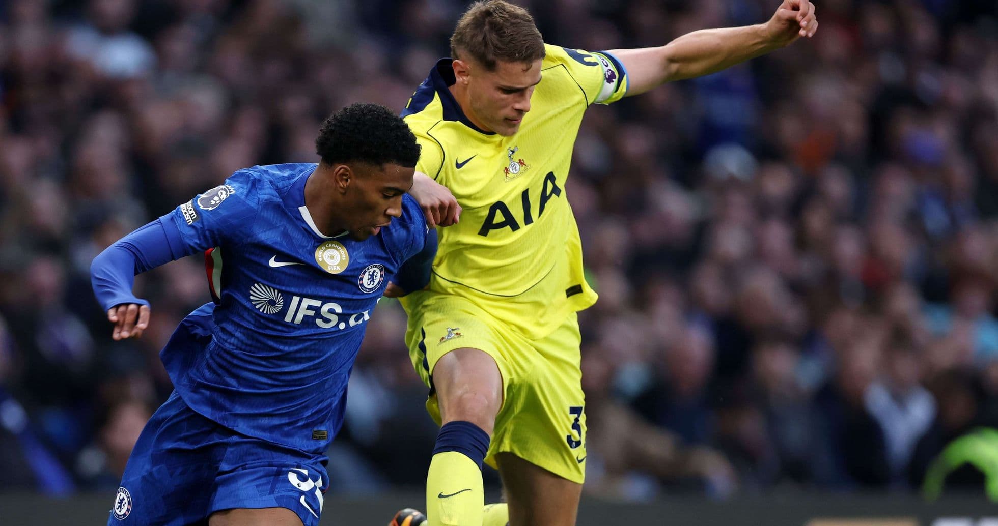 Chelsea player challenges Tottenham opponent for the ball