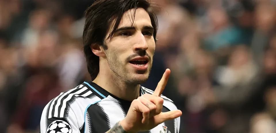 Player gesturing during match with fans in background