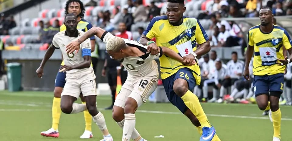 Orlando Pirates player challenged by La Cure Waves opponent