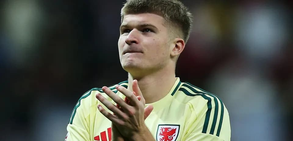Player in yellow jersey applauding after match