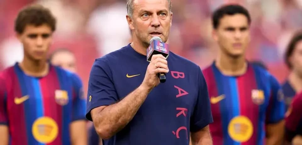 Manager speaking at event with players in background