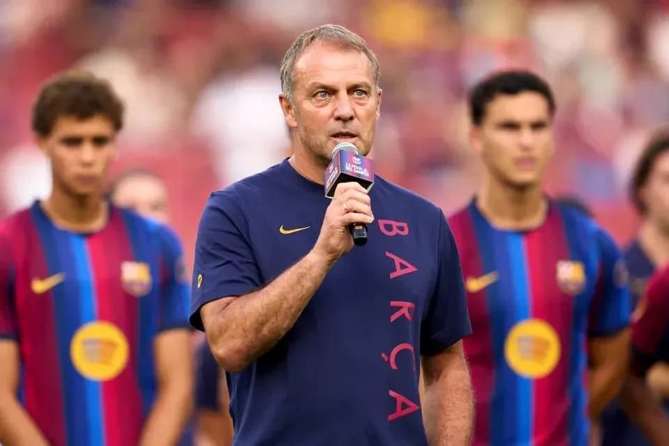 Manager speaking at event with players in background