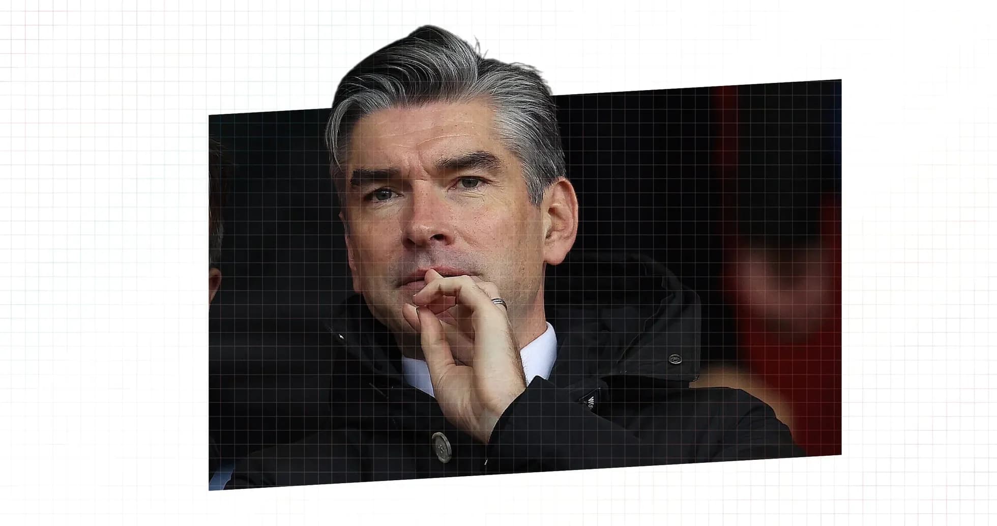 Man observing match from the stands in a coat