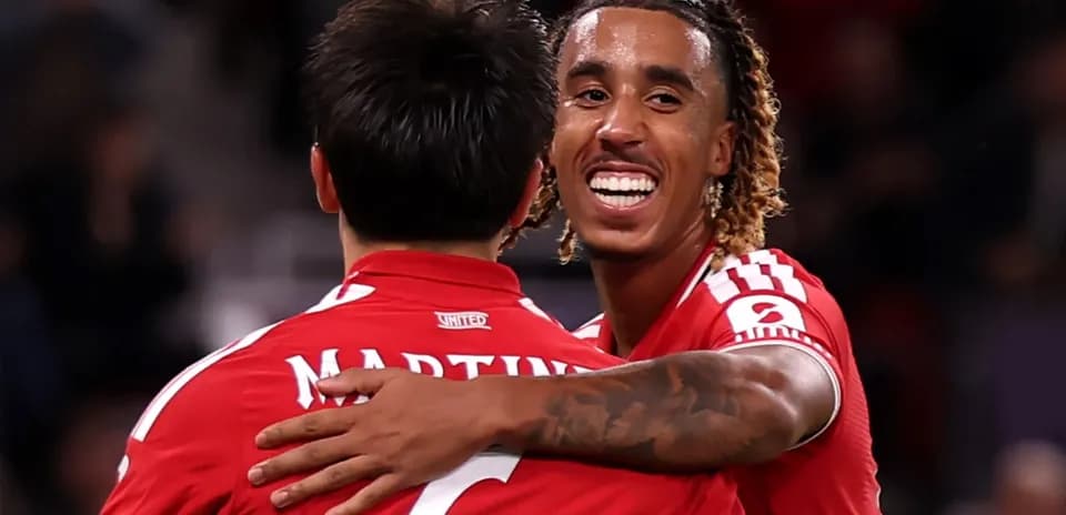 Two players celebrating together on the pitch
