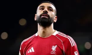 Player wearing Liverpool jersey looking upwards