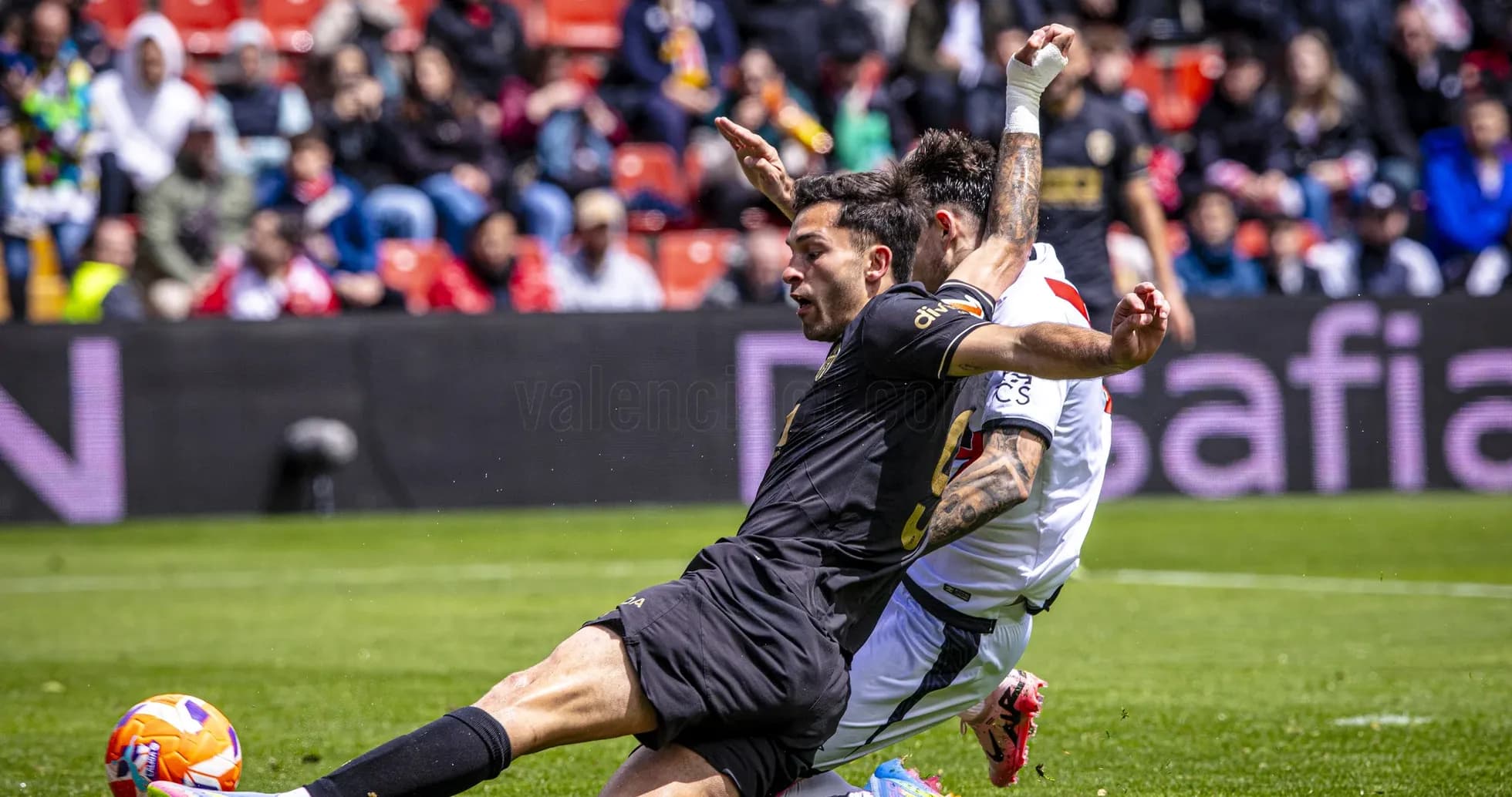 Player tackling opponent during Valencia match