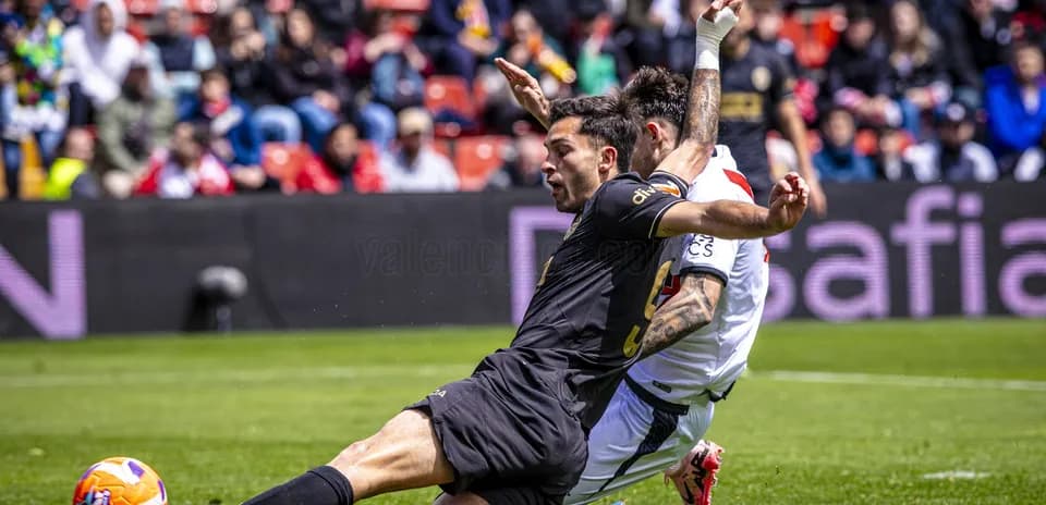Player tackling opponent during Valencia match