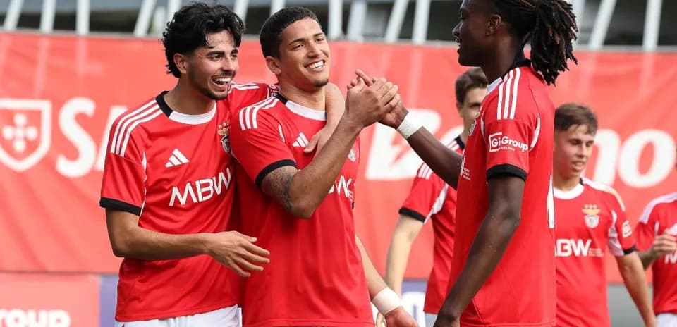 Benfica players celebrating together on the field