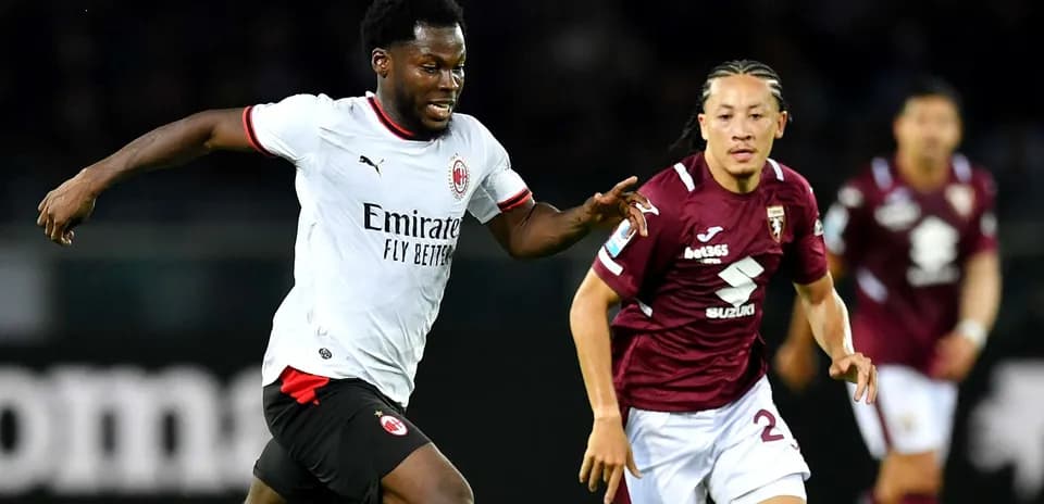 AC Milan player running past Torino defender