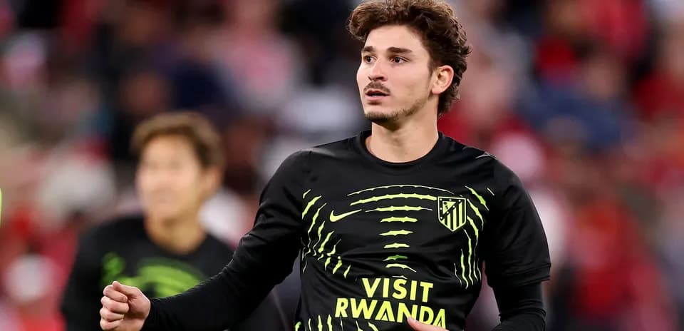 Player warming up in Atletico Madrid training shirt