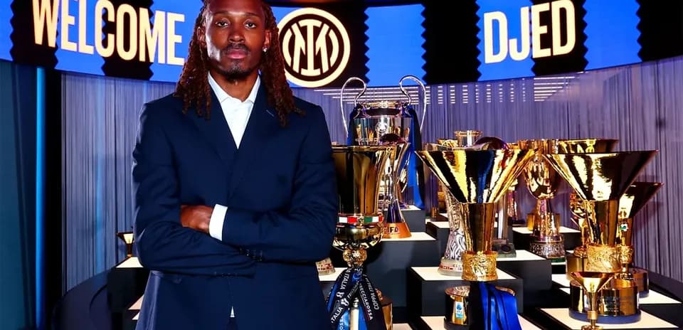 Player posing with trophies at welcome event