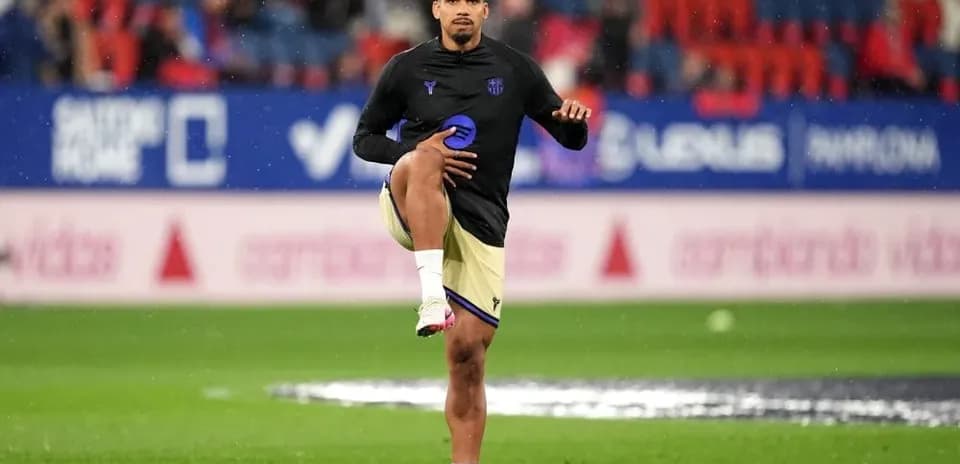 Player stretching on the pitch during warm-up