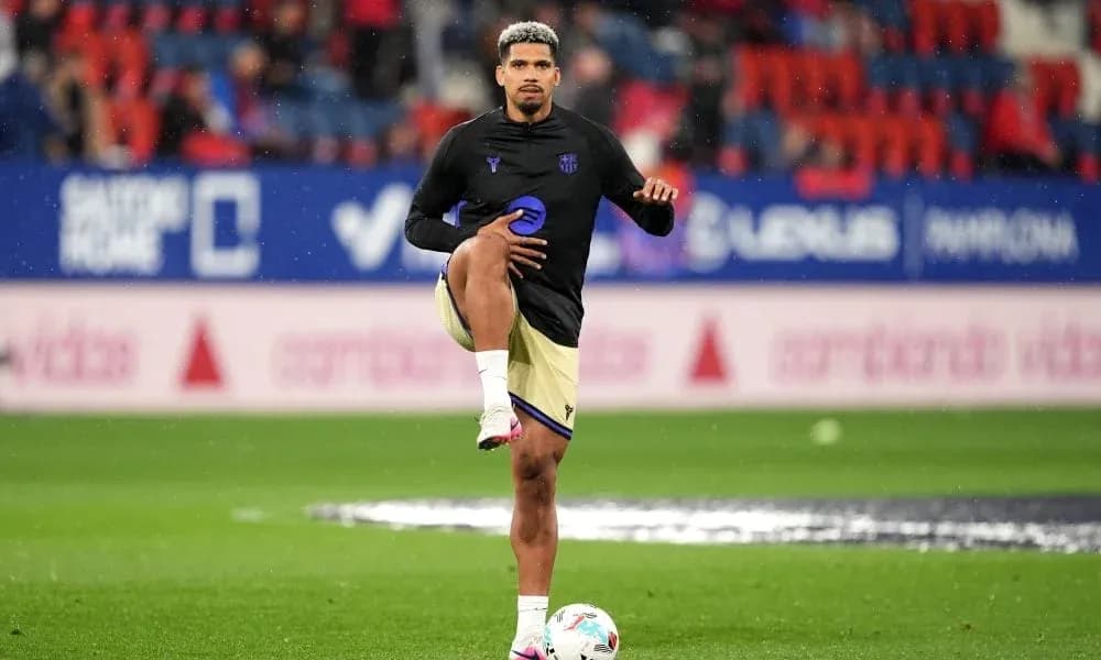Player stretching on the pitch during warm-up