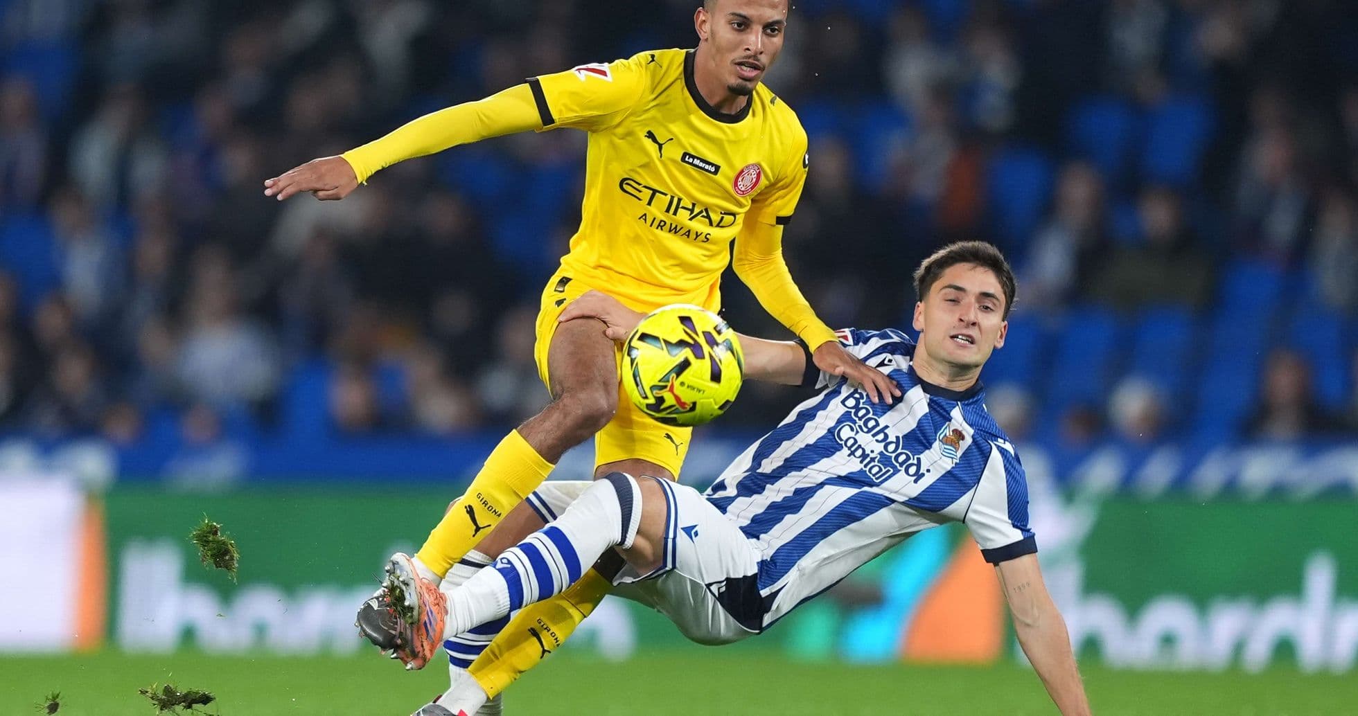 Player tackling during Girona vs Real Sociedad match
