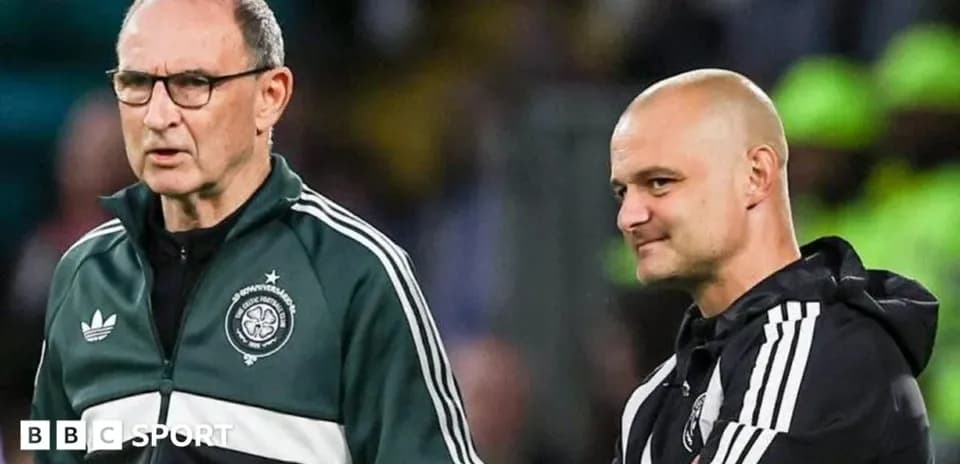 Two coaches discussing during a football match
