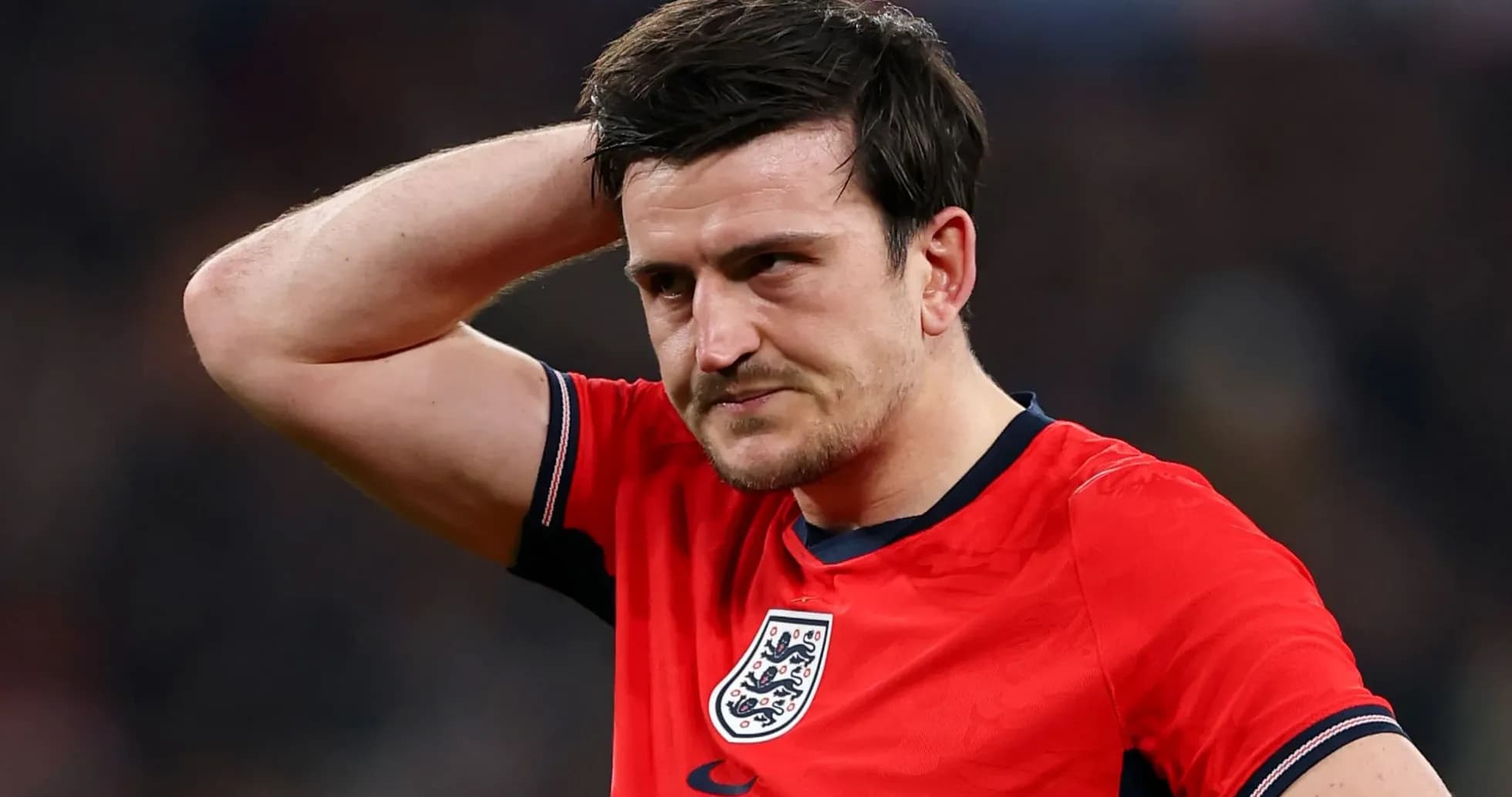 Player in red England jersey looking concerned