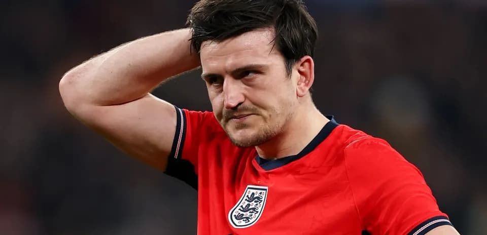 Player in red England jersey looking concerned
