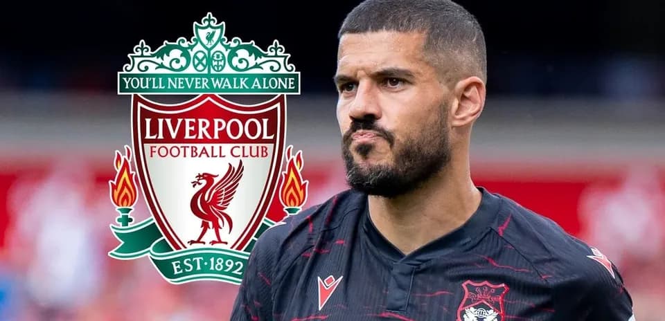 Player in black kit with Liverpool FC logo