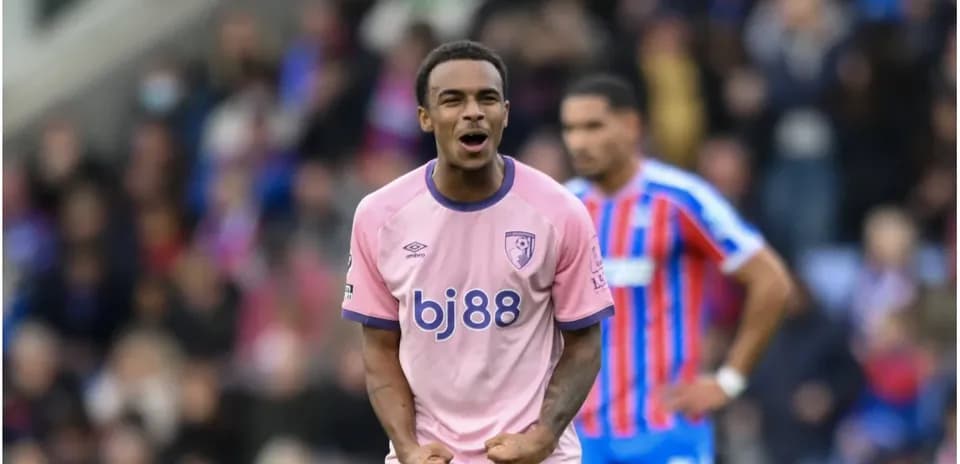 Player celebrating in pink jersey during match