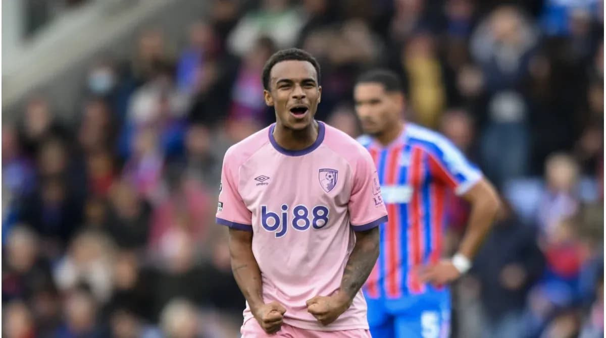 Player celebrating in pink jersey during match