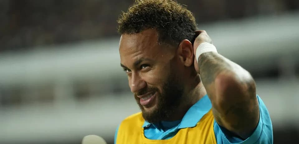 Neymar adjusting his hair on the sideline